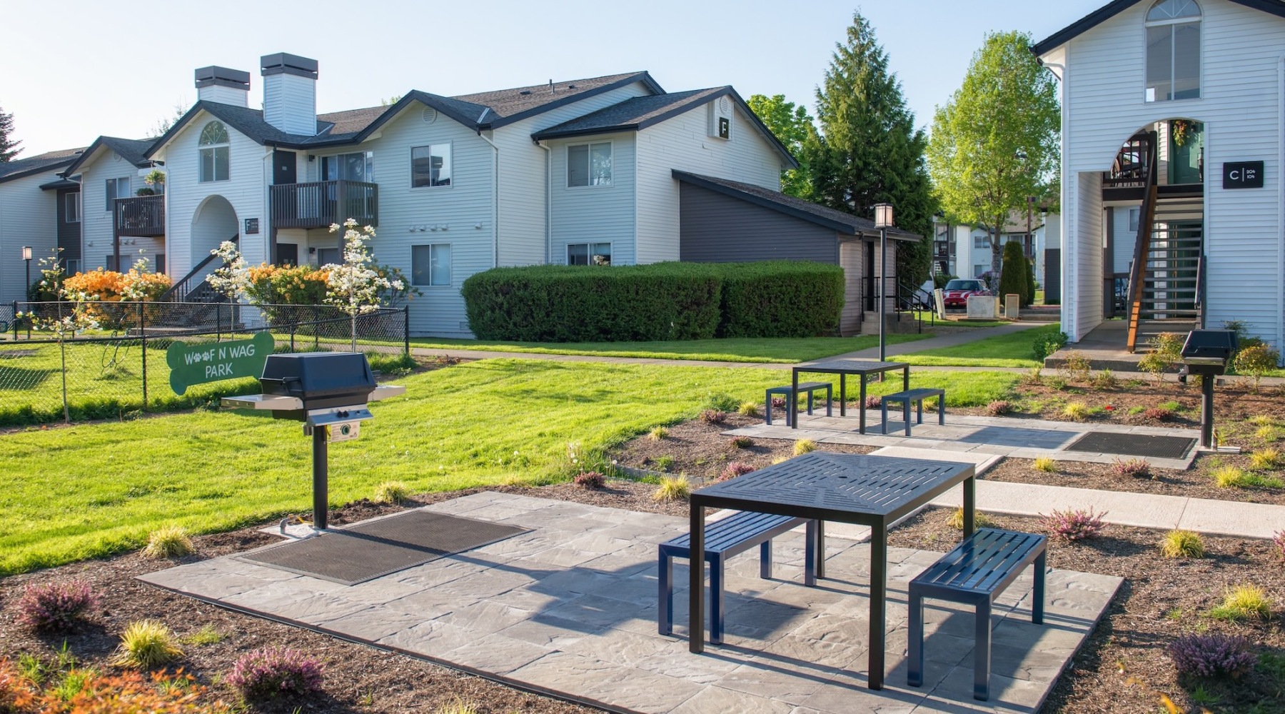 a backyard with a grill and dog park