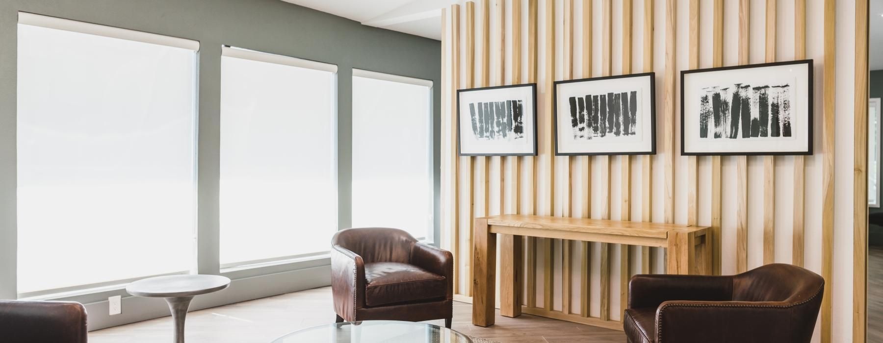 a room with a table chairs and a window