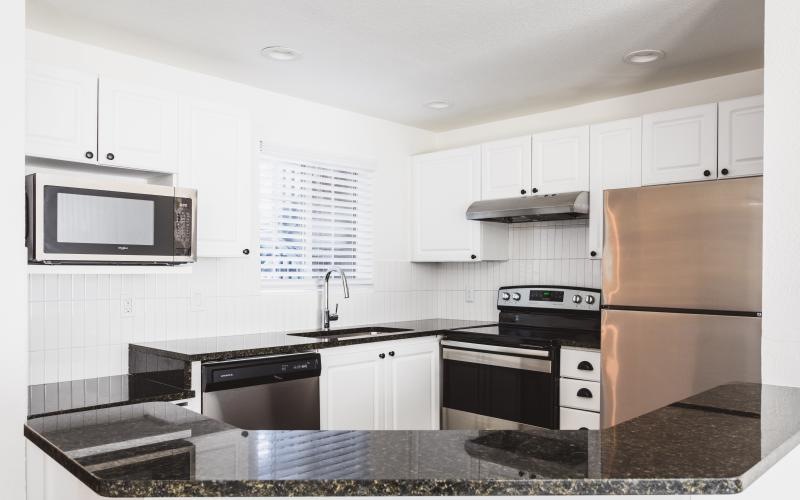 a kitchen with white cabinets