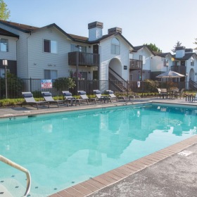 a swimming pool in front of a row of houses