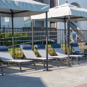 a patio with chairs and umbrellas