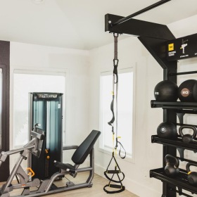 a room with exercise equipment and a window
