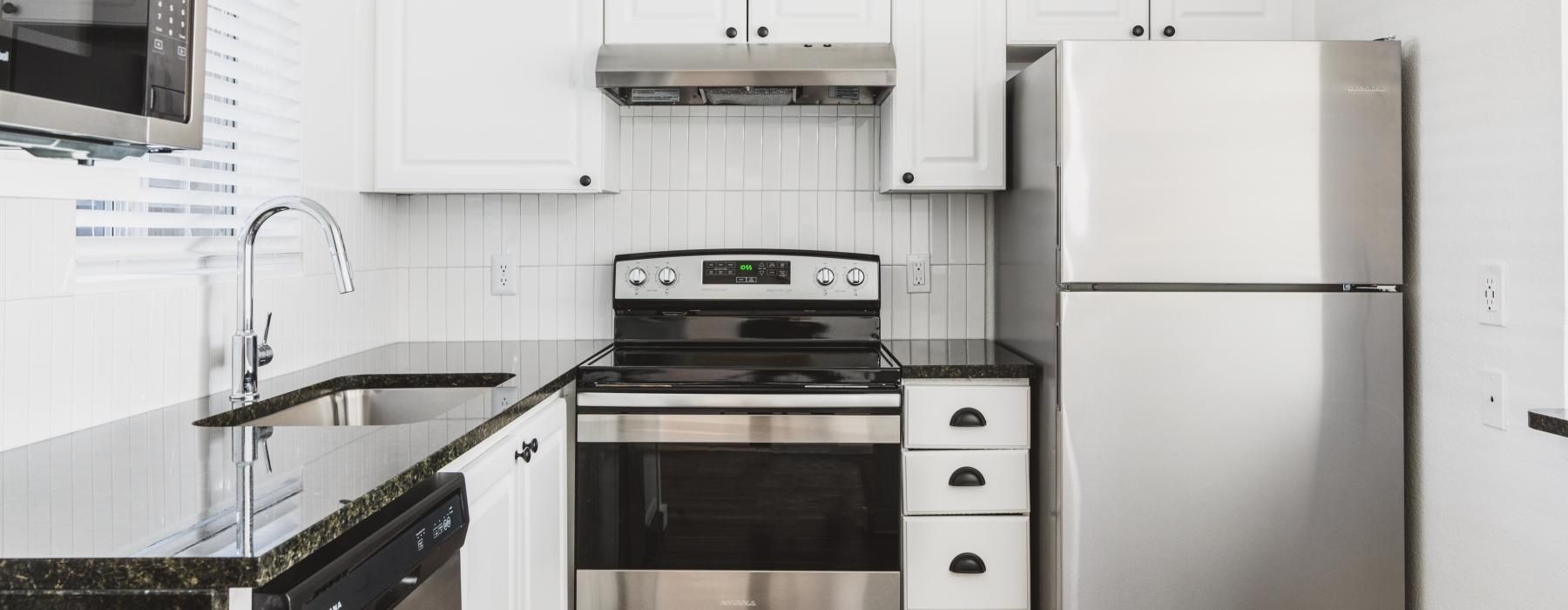 a kitchen with white cabinets